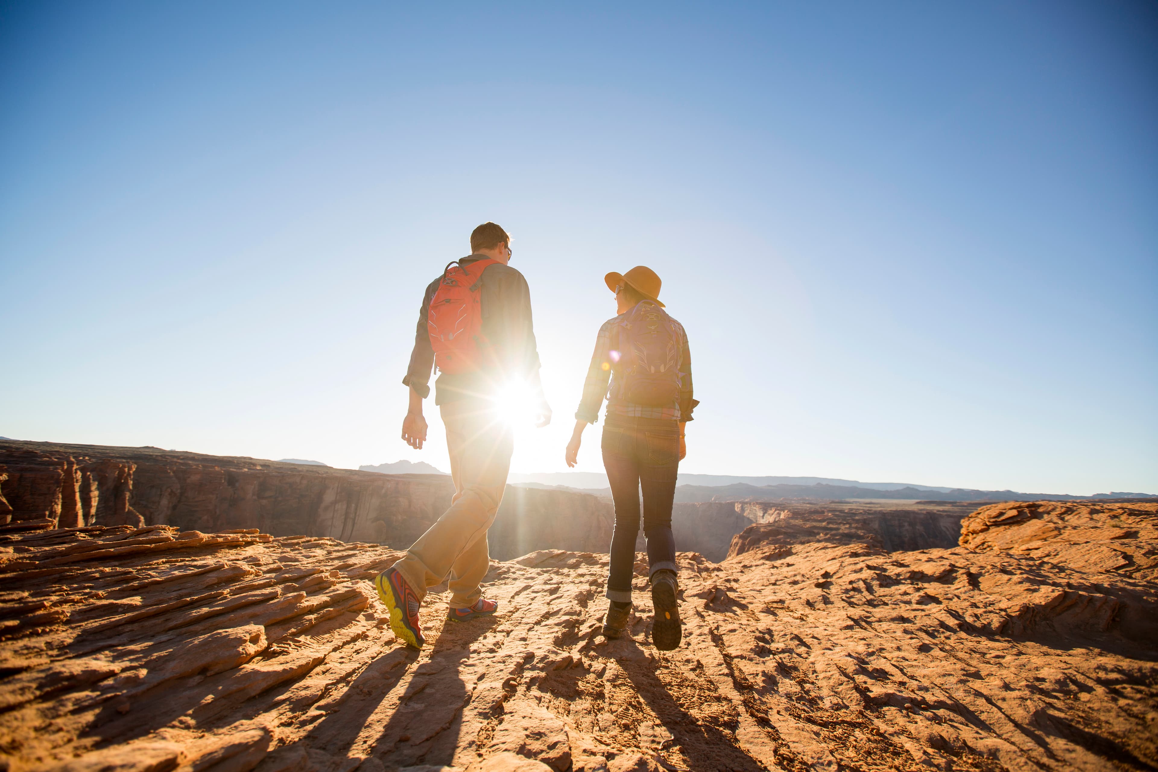 A couple hiking to an overlook at Horseshoe Bend, Arizona.