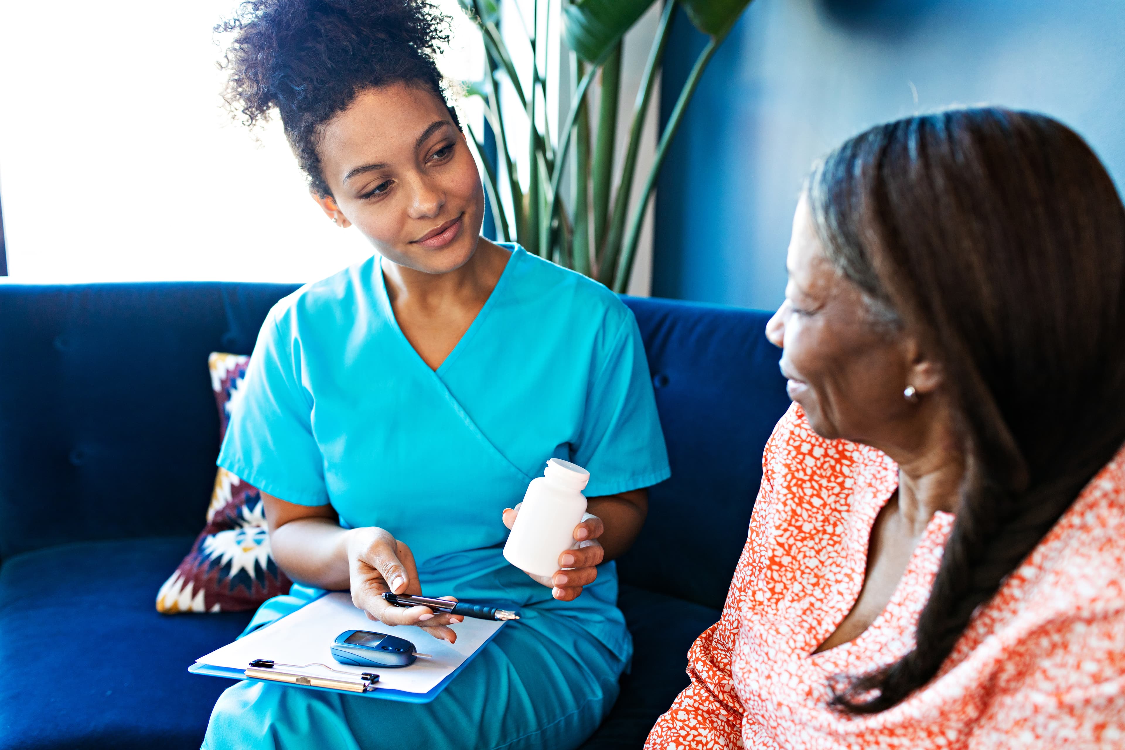 Nurse visiting a mature female patient at home