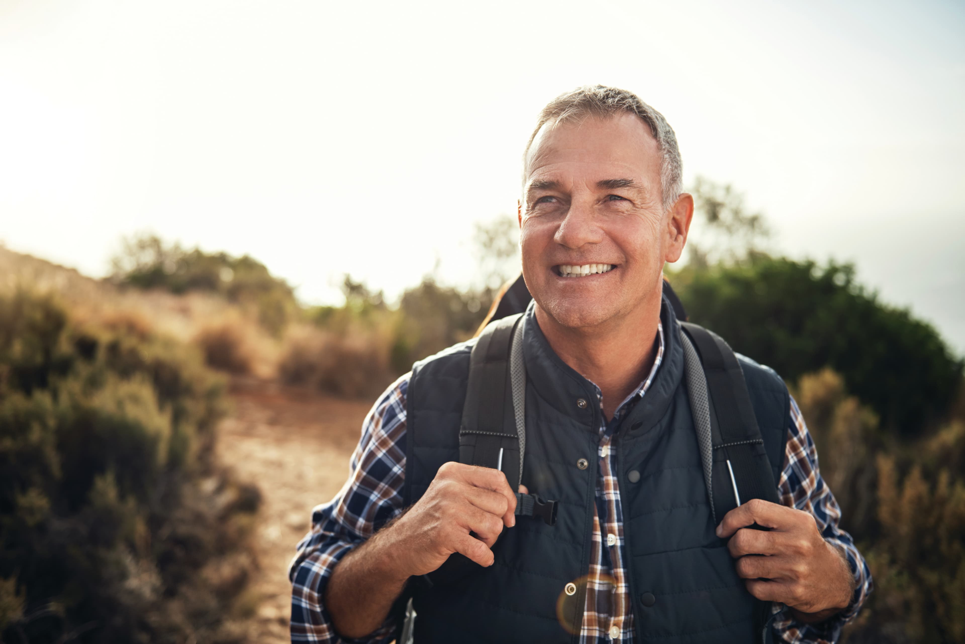 Shot of a mature man hiking through the mountains