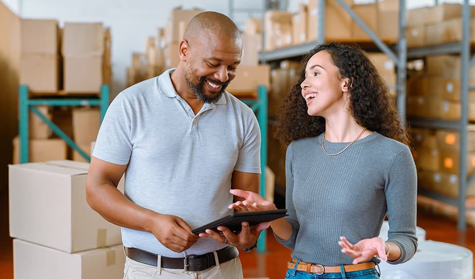 1255014654 man woman working warehouse